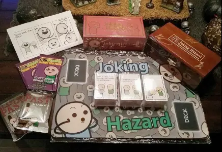 All components of the Joking Hazard game layed out on a table